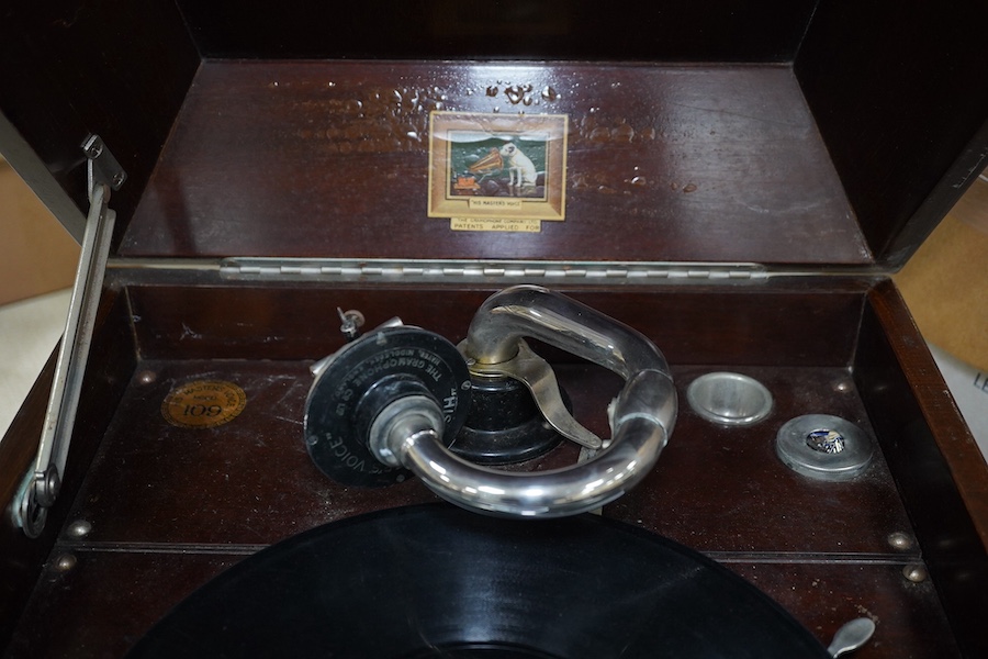 A mahogany cased HMV table top gramophone record player and a small selection of 78 rpm records. Condition - fair to good.